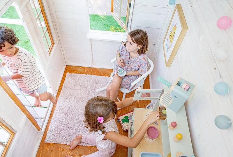 Petits Belges jouant dans une cabane en bois à l'extérieur