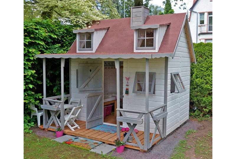 Enfants jouant dans une cabane en bois à l'extérieur