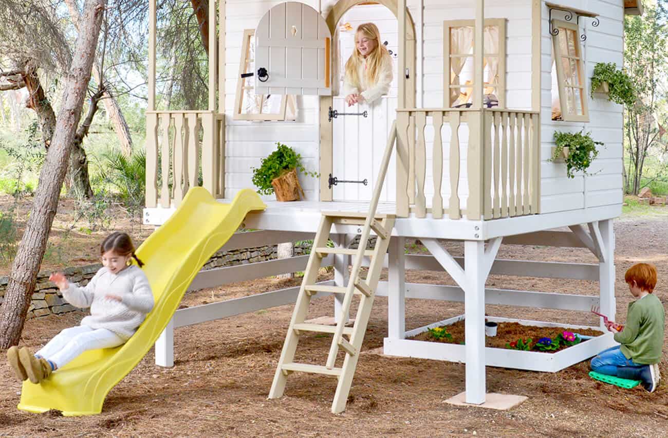 Crianças brincando em uma casinha de madeira ao ar livre